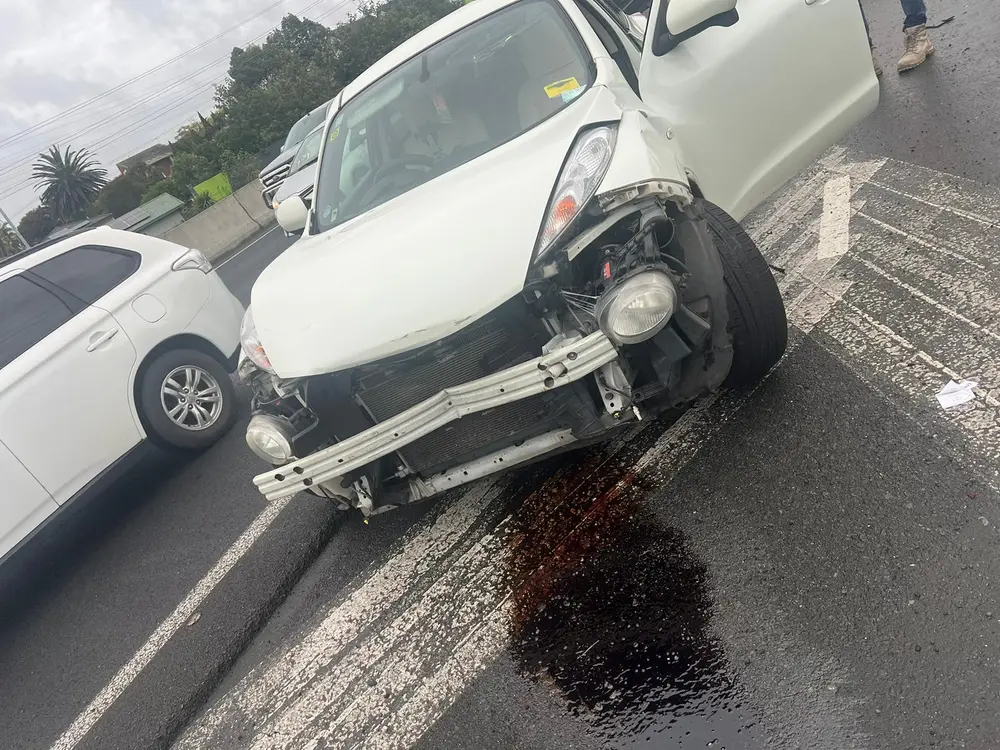 White Suzuki Swift with major front-end crash damage