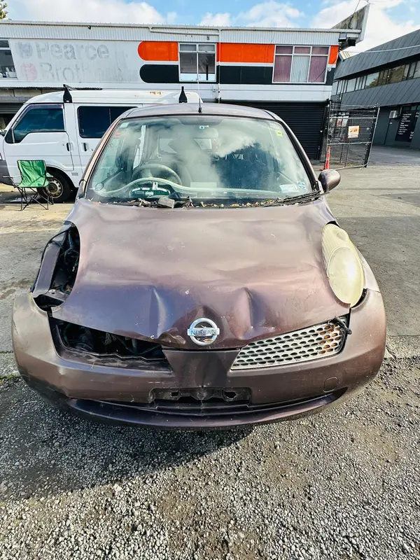 Nissan March with a smashed front bumper