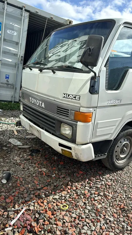 Toyota Hiace light truck parked on gravel